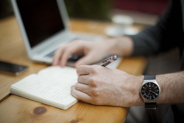 Man Writing In Book