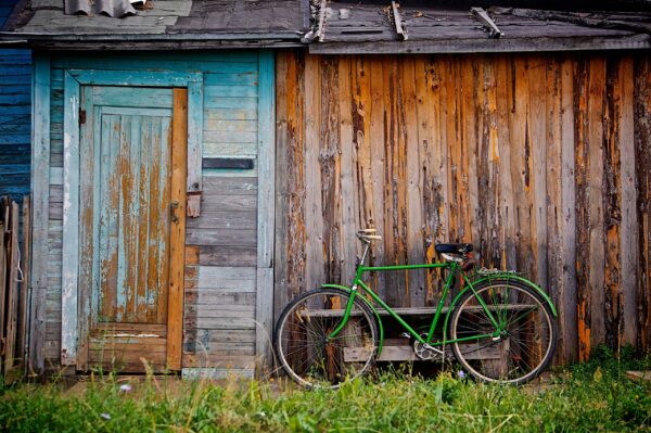 Old Wooden Wendy House and Green Bicycle